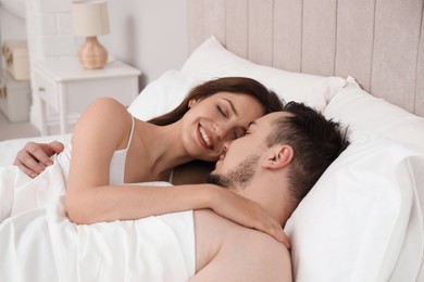 Lovely couple enjoying time together in bed at morning