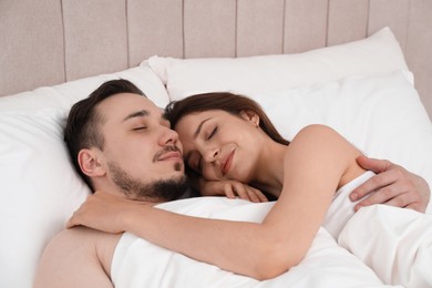 Lovely couple sleeping together in bed at morning