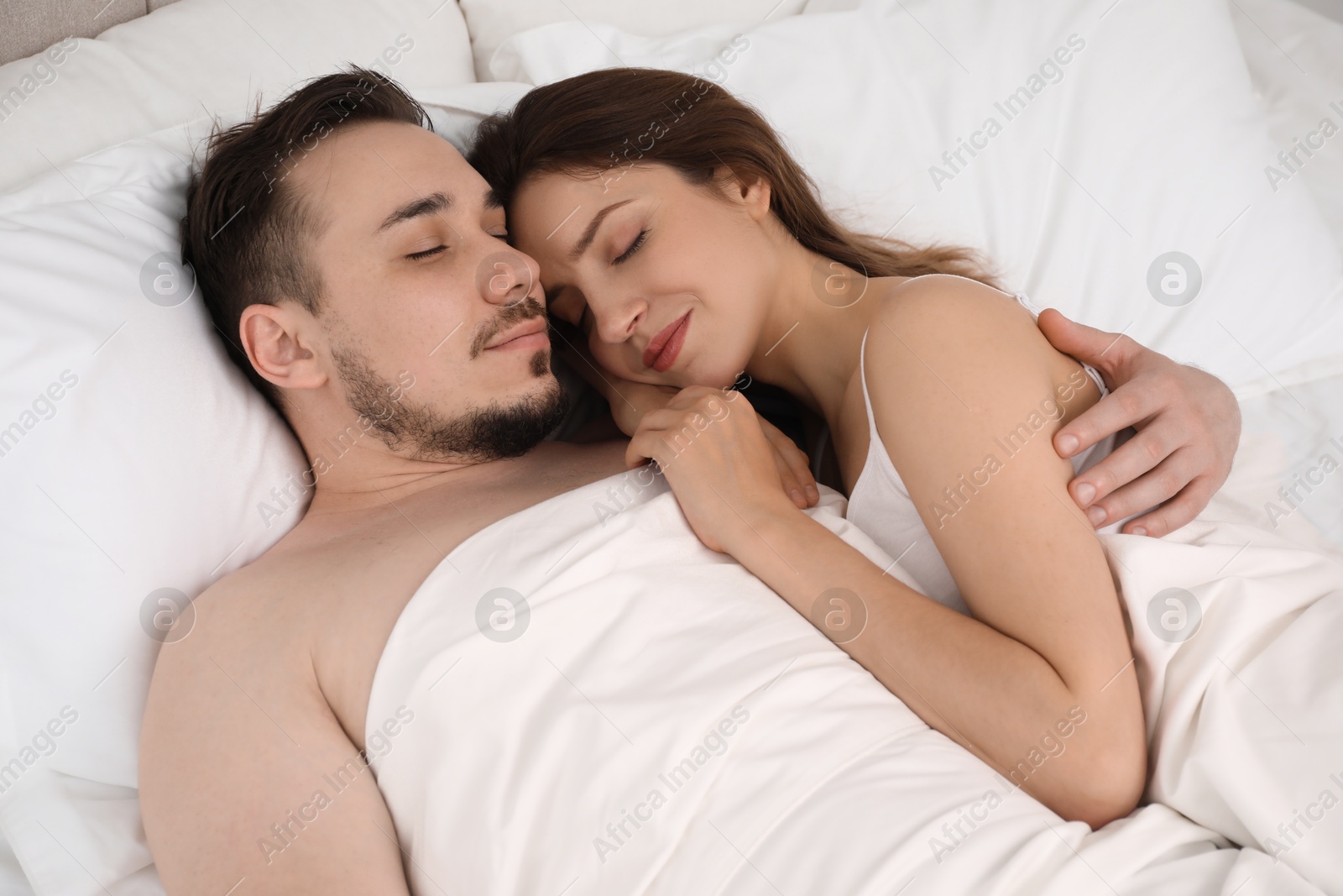 Photo of Lovely couple sleeping together in bed at morning