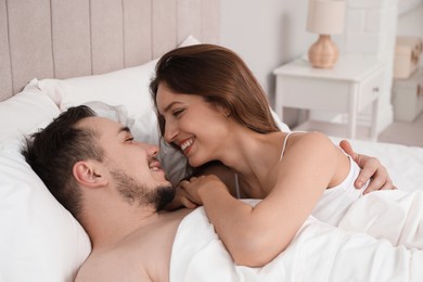 Lovely couple enjoying time together in bed at morning