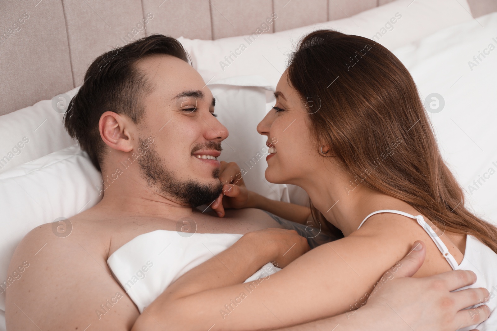 Photo of Lovely couple enjoying time together in bed at morning