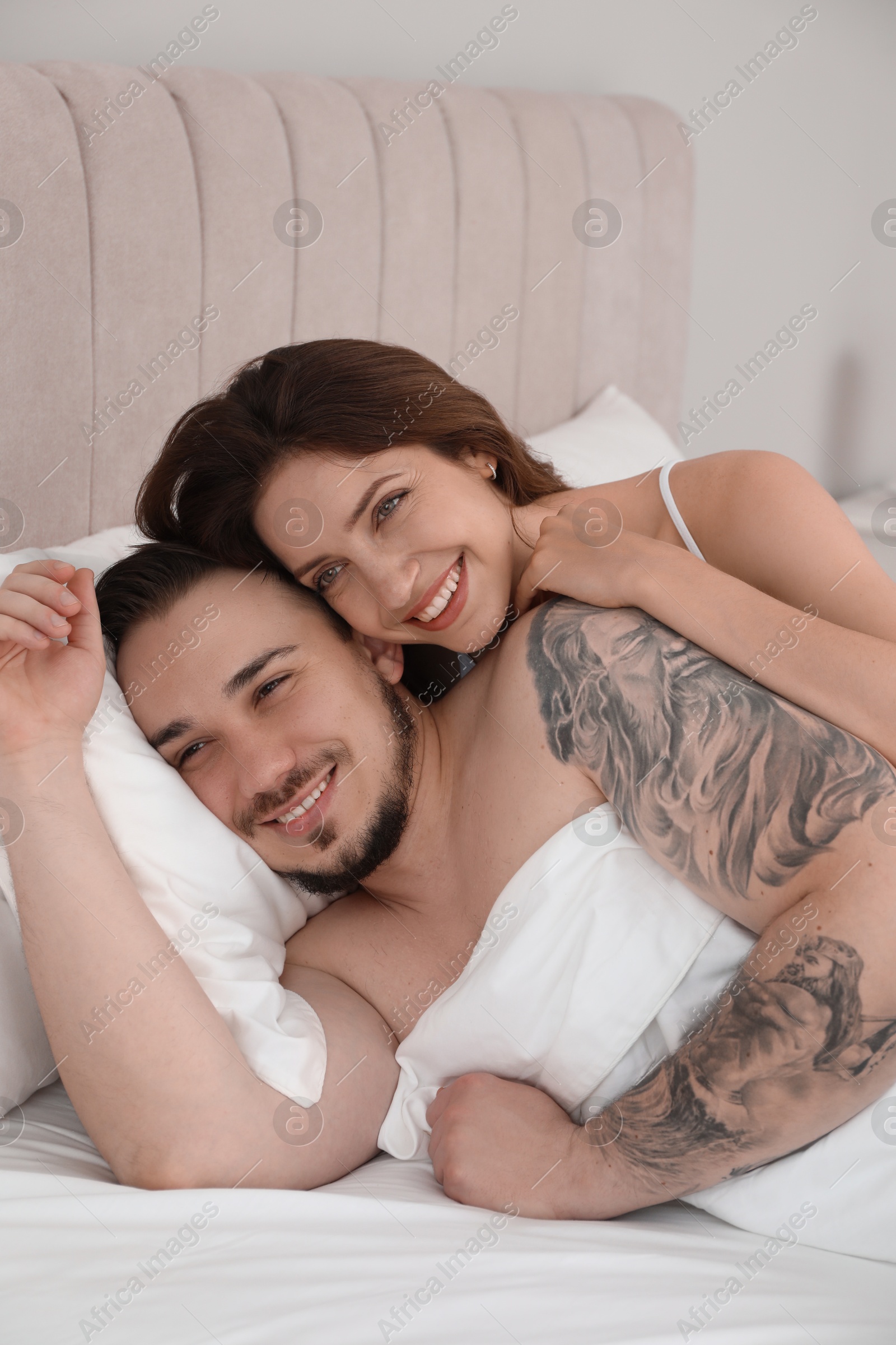 Photo of Lovely couple enjoying time together in bed at morning