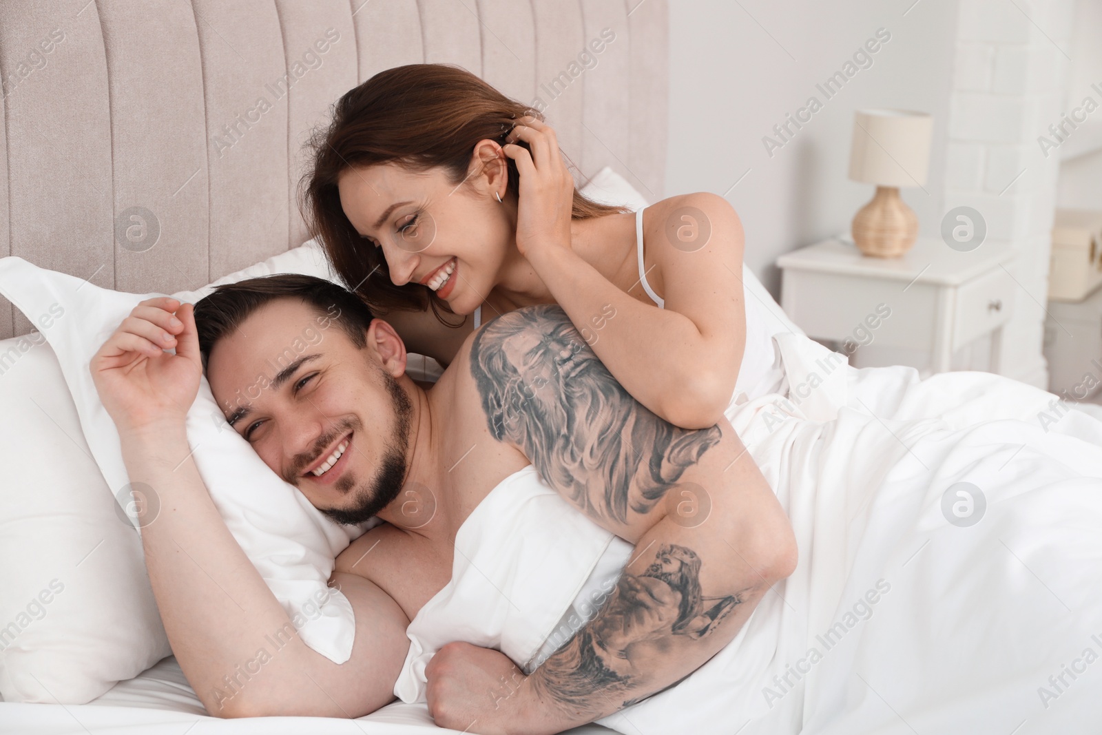 Photo of Lovely couple enjoying time together in bed at morning