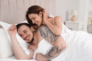 Photo of Lovely couple enjoying time together in bed at morning