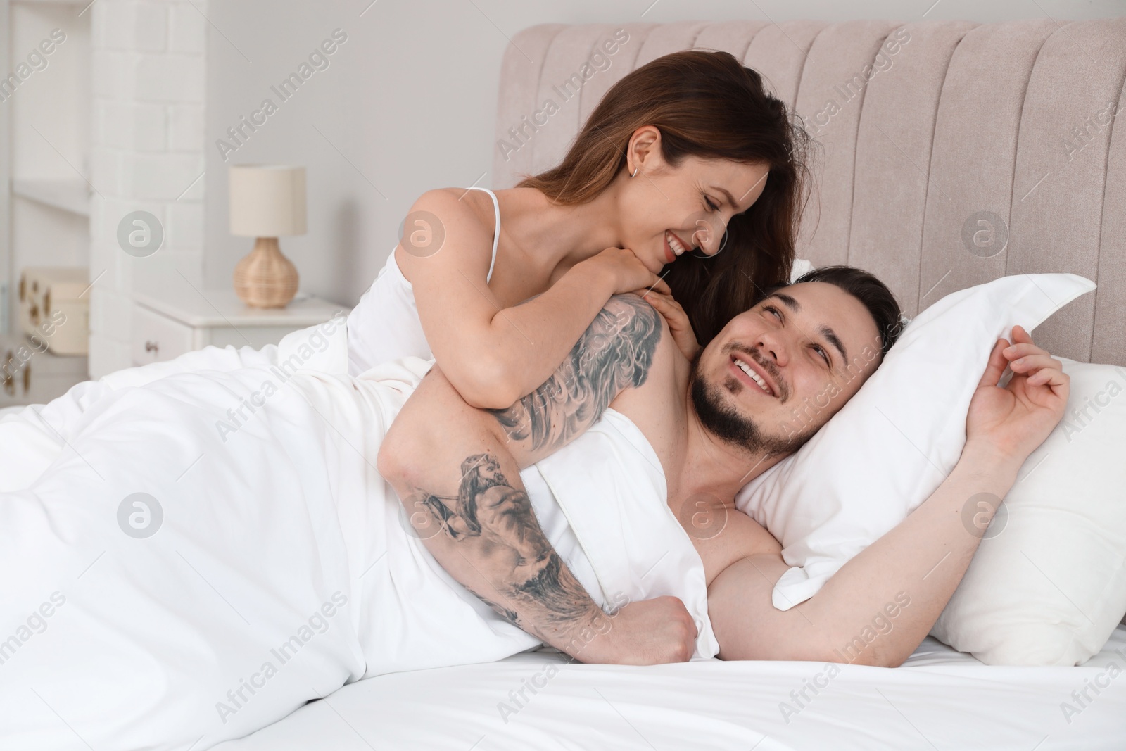 Photo of Lovely couple enjoying time together in bed at morning