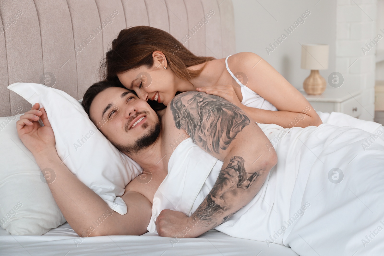 Photo of Lovely couple enjoying time together in bed at morning