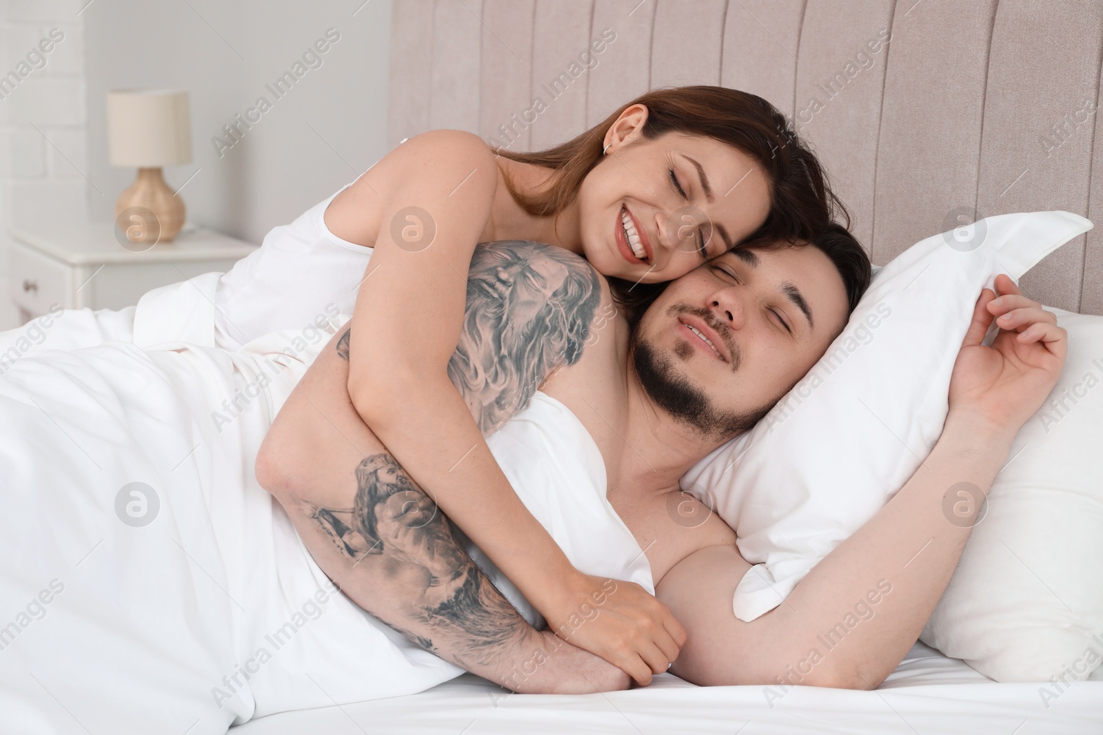 Photo of Lovely couple enjoying time together in bed at morning