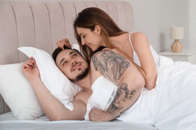 Lovely couple enjoying time together in bed at morning