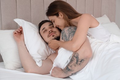 Lovely couple enjoying time together in bed at morning