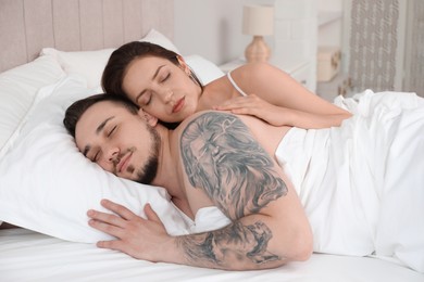 Photo of Lovely couple sleeping together in bed at home