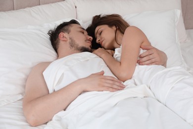 Lovely couple sleeping together in bed at home