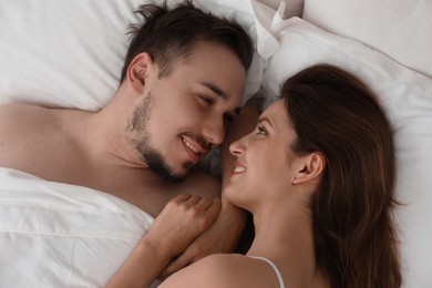 Photo of Lovely couple enjoying time together in bed at morning, closeup