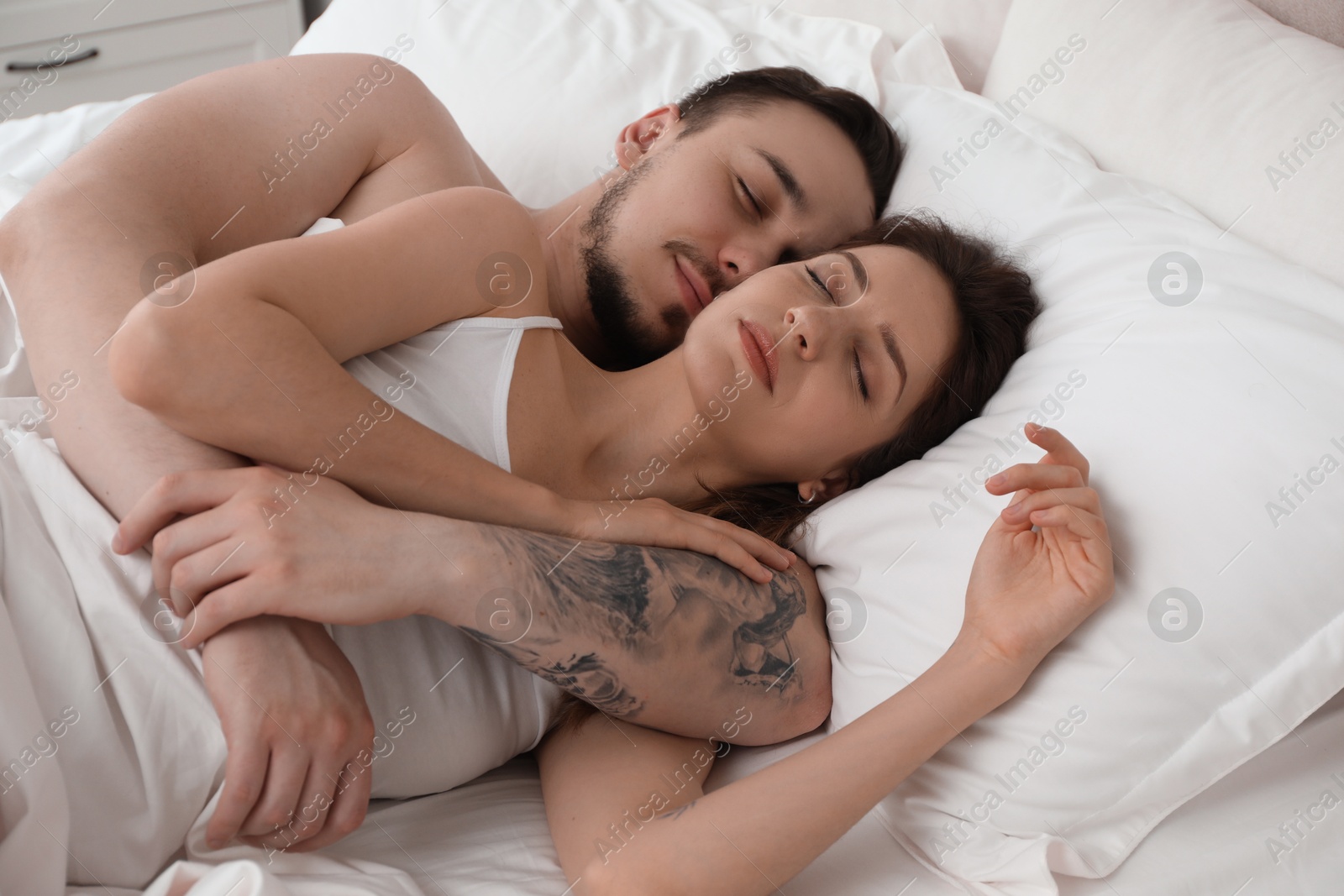 Photo of Lovely couple sleeping together in bed at home