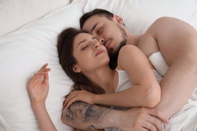 Lovely couple sleeping together in bed at home