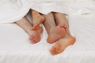 Lovely couple lying in bed at home, closeup view