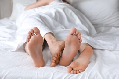 Lovely couple lying in bed at home, closeup view