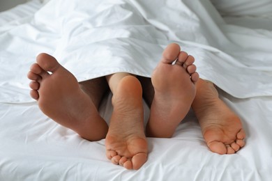 Photo of Lovely couple lying in bed at home, closeup view