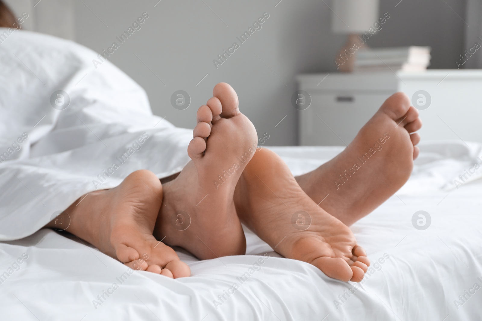 Photo of Lovely couple lying in bed at home, closeup view