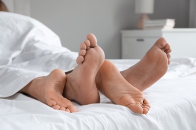 Lovely couple lying in bed at home, closeup view
