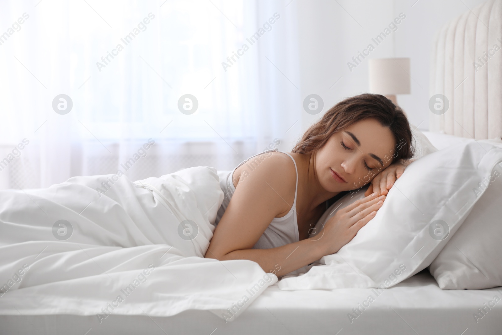 Photo of Bedtime. Beautiful woman sleeping in bed at morning