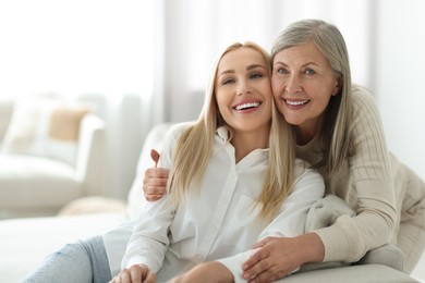 Photo of Family portrait of young woman and her mother at home. Space for text