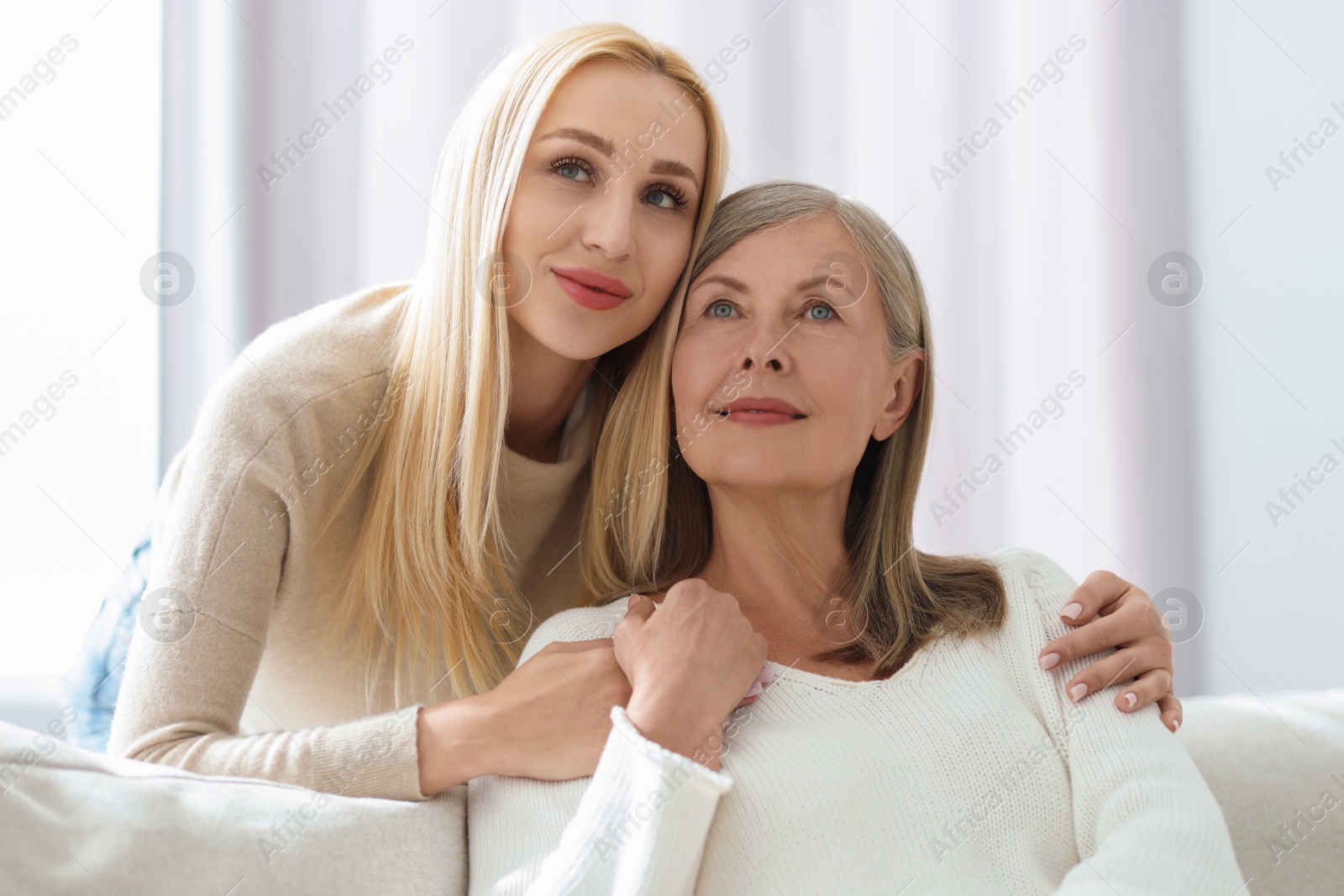 Photo of Family portrait of young woman and her mother at home