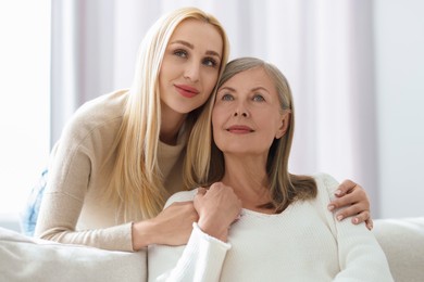 Family portrait of young woman and her mother at home