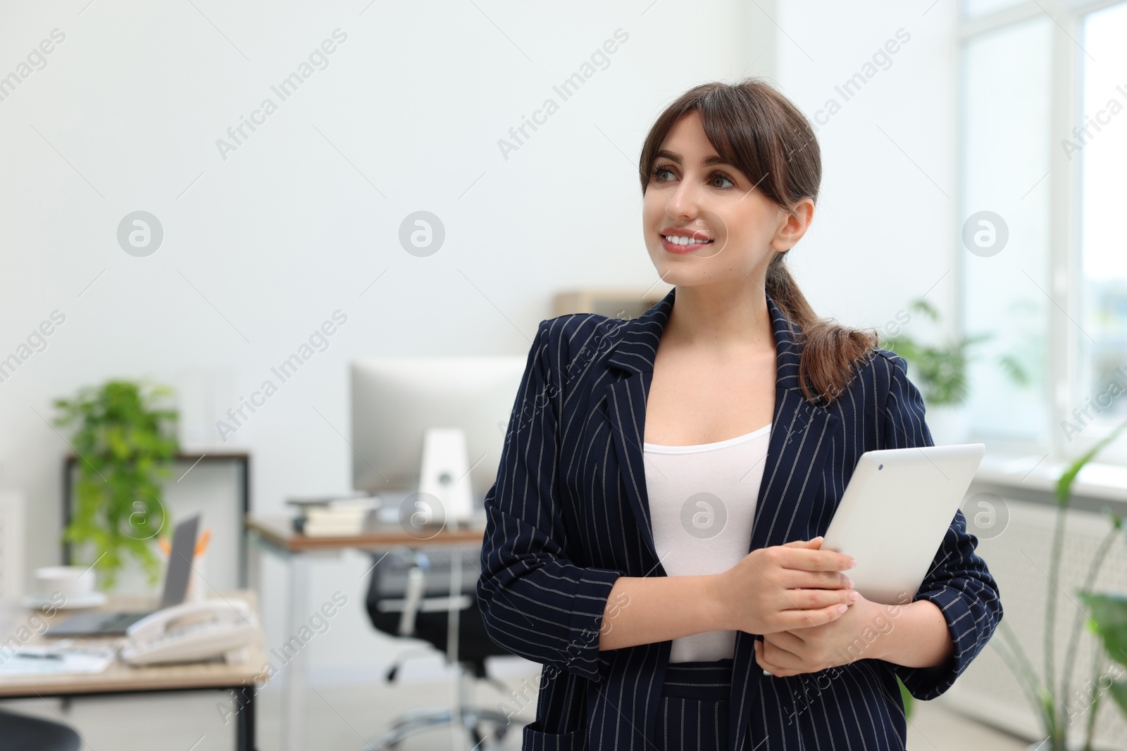 Photo of Portrait of smiling secretary with tablet in office. Space for text