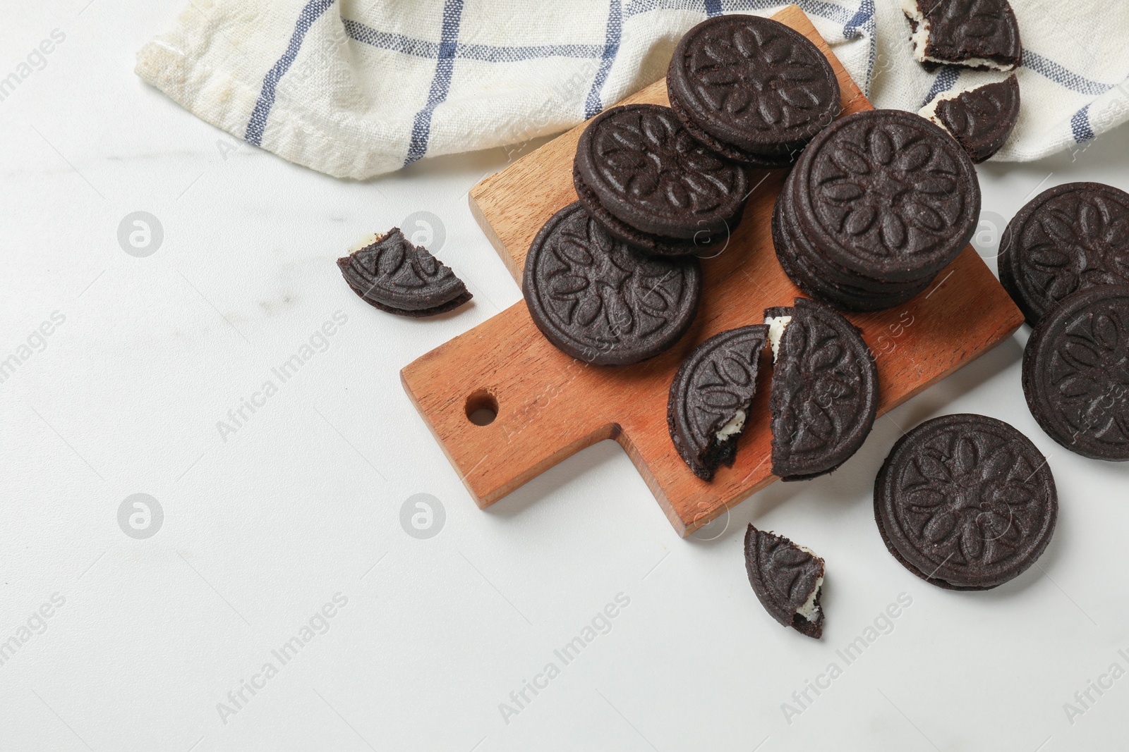 Photo of Tasty sandwich cookies on white table, flat lay. Space for text