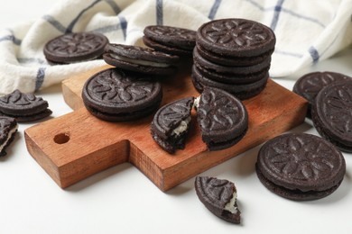 Photo of Tasty sandwich cookies on white table, closeup