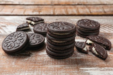 Photo of Tasty sandwich cookies on wooden rustic table, closeup