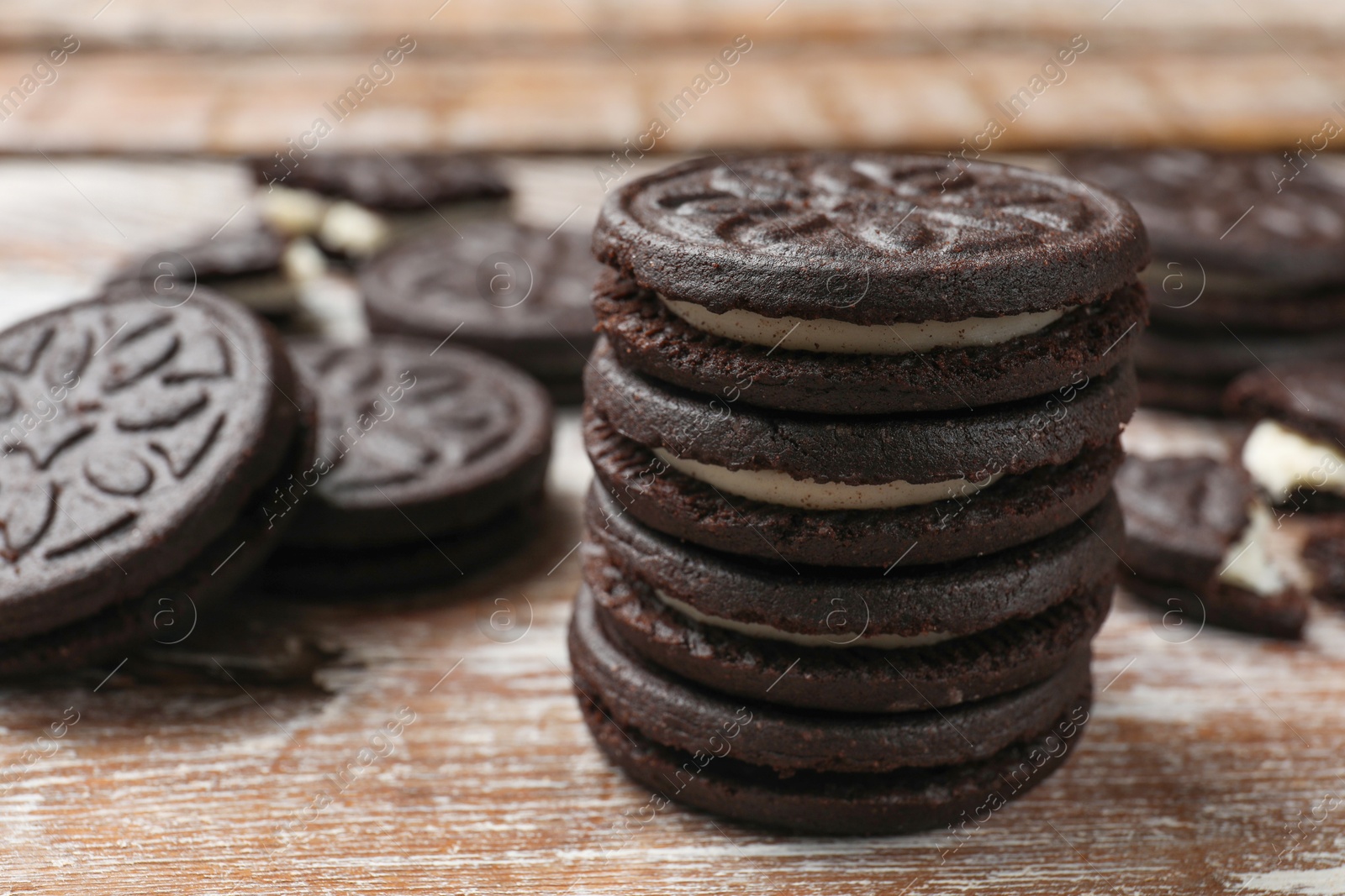 Photo of Tasty sandwich cookies on wooden rustic table, closeup