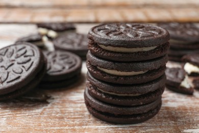 Photo of Tasty sandwich cookies on wooden rustic table, closeup