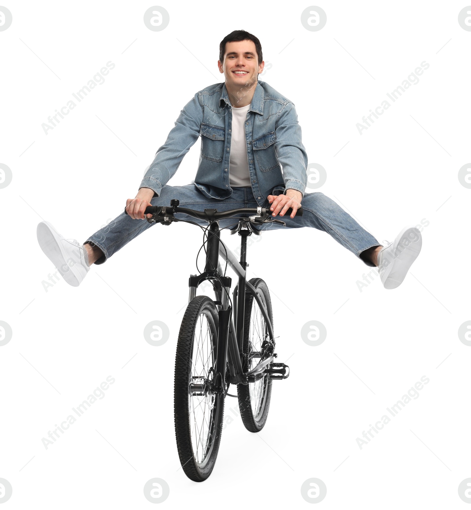 Photo of Smiling man having fun while riding bicycle on white background