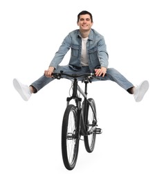 Smiling man having fun while riding bicycle on white background