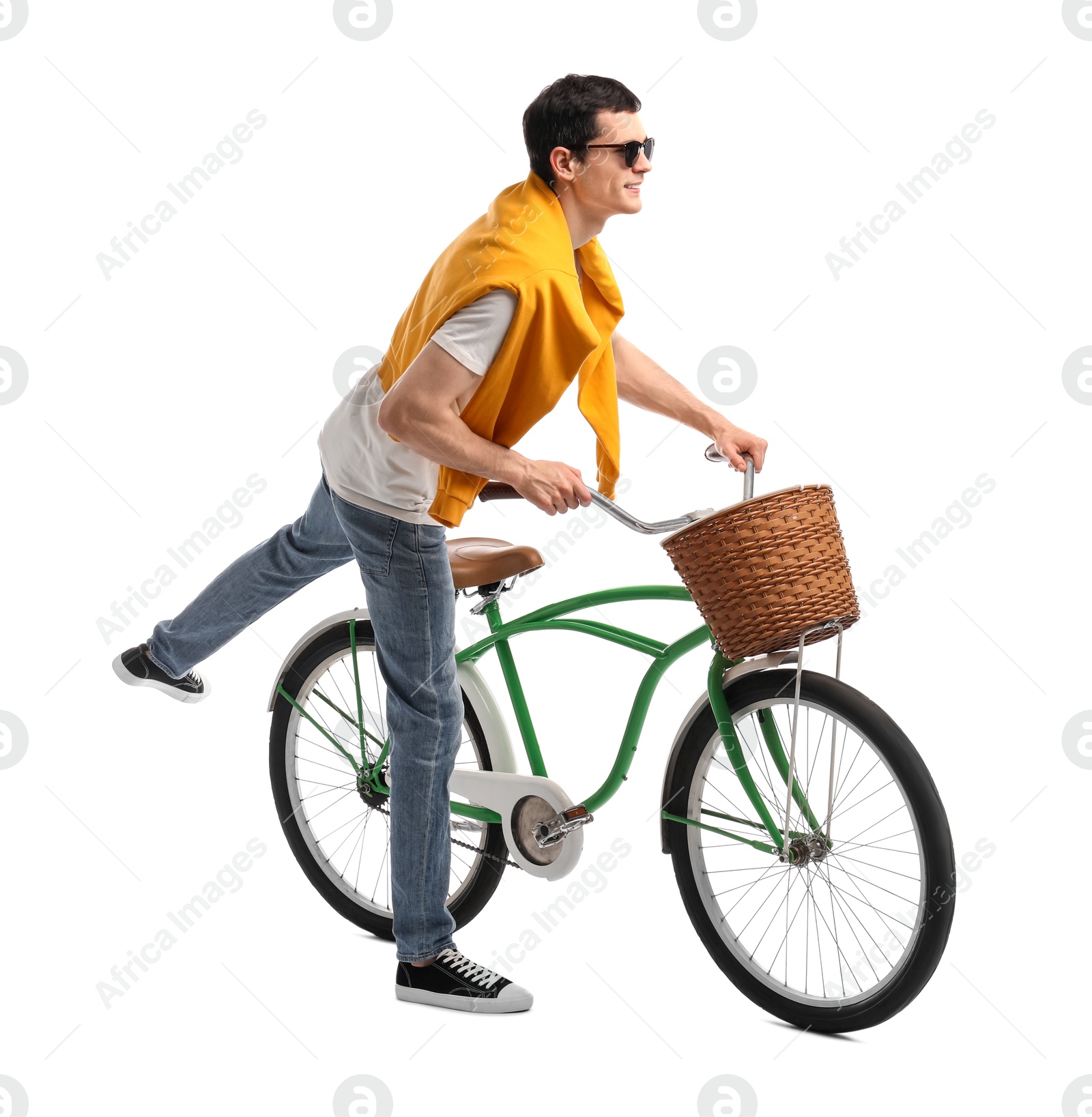 Photo of Smiling man in sunglasses riding bicycle with basket on white background