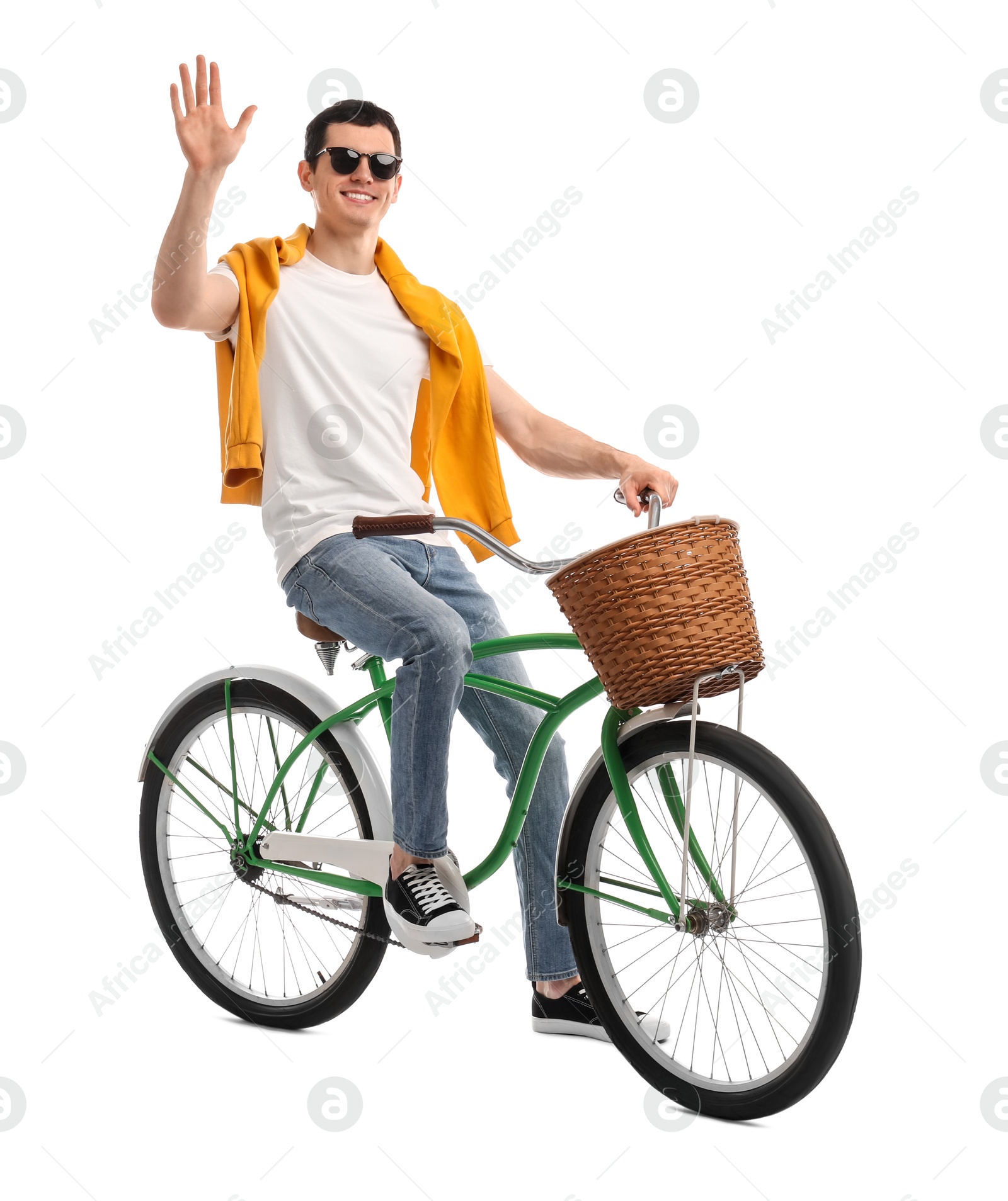 Photo of Smiling man in sunglasses riding bicycle with basket on white background