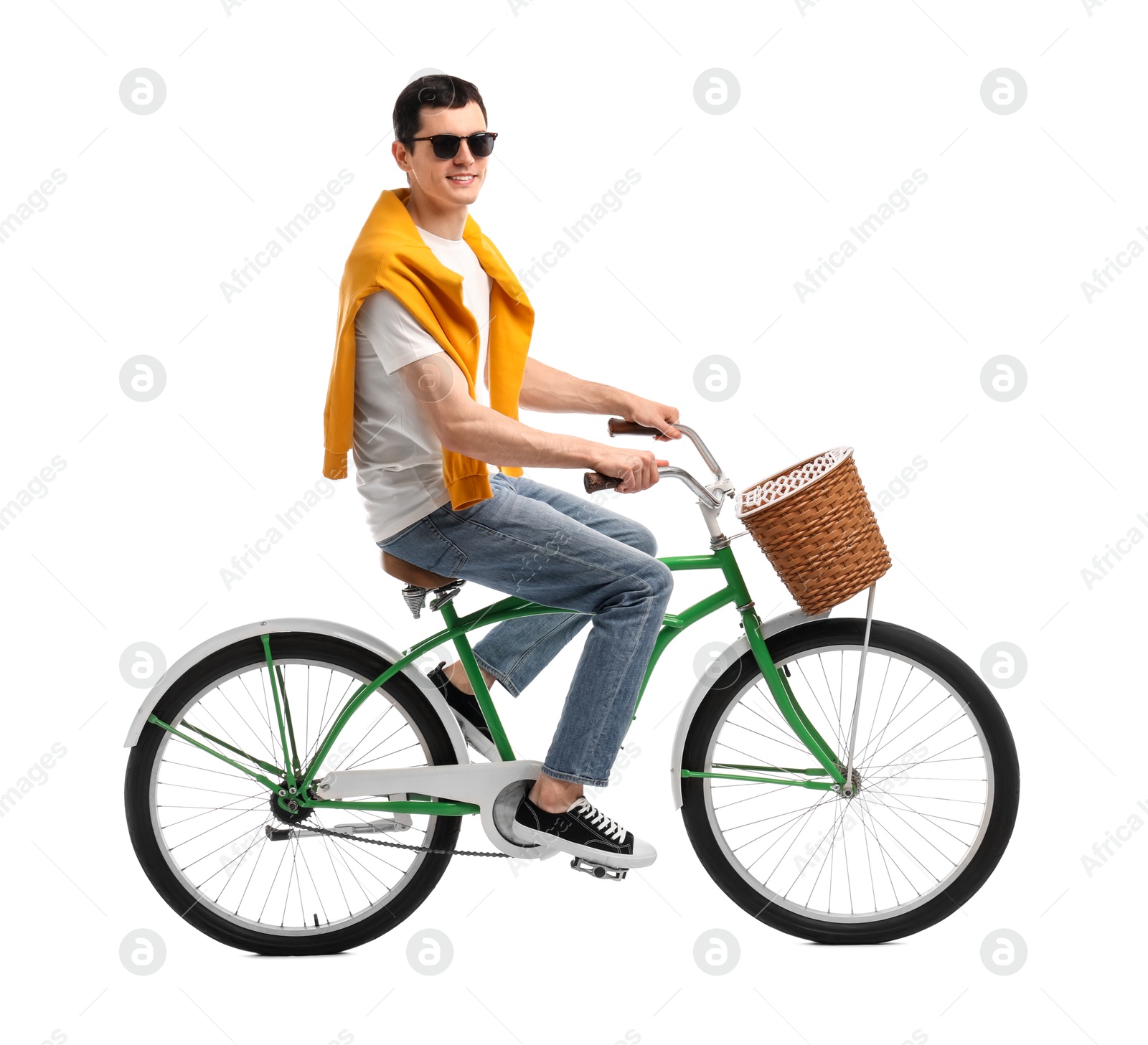 Photo of Smiling man in sunglasses riding bicycle with basket on white background