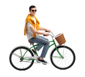 Smiling man in sunglasses riding bicycle with basket on white background