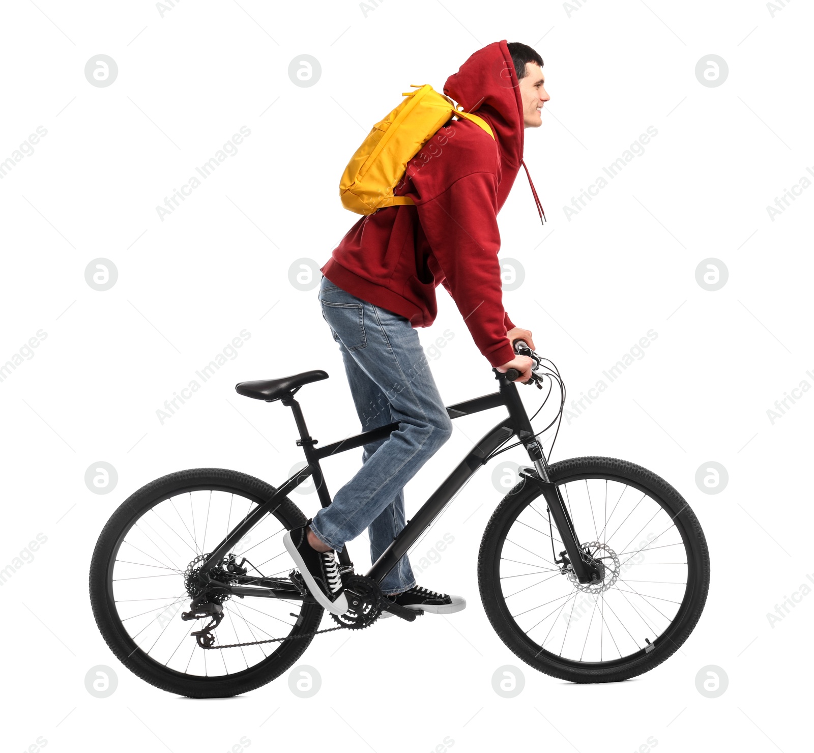 Photo of Smiling man with backpack riding bicycle on white background