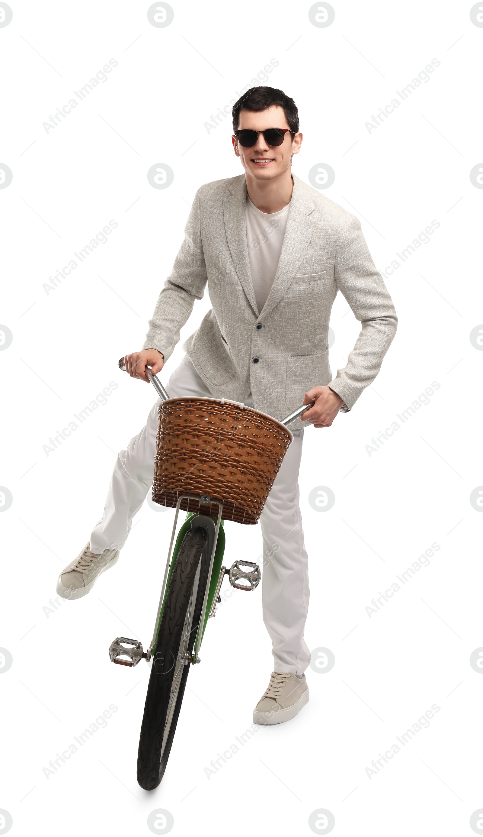 Photo of Smiling man in sunglasses riding bicycle with basket on white background