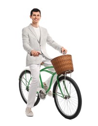 Smiling man on bicycle with basket against white background