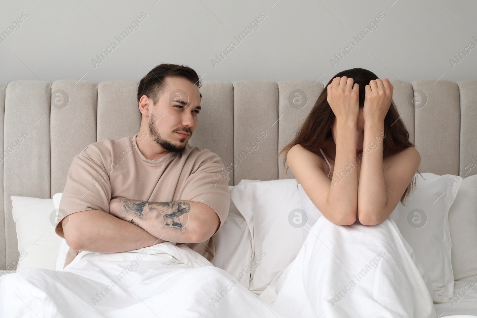 Photo of Offended couple after quarrel in bedroom. Relationship problem