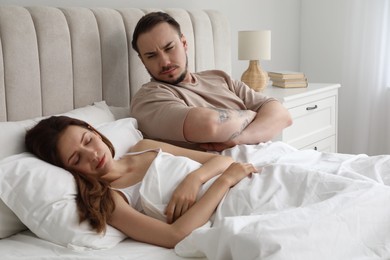Offended couple after quarrel in bedroom. Relationship problem