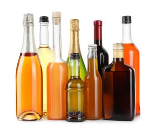 Photo of Bottles of different alcoholic drinks isolated on white