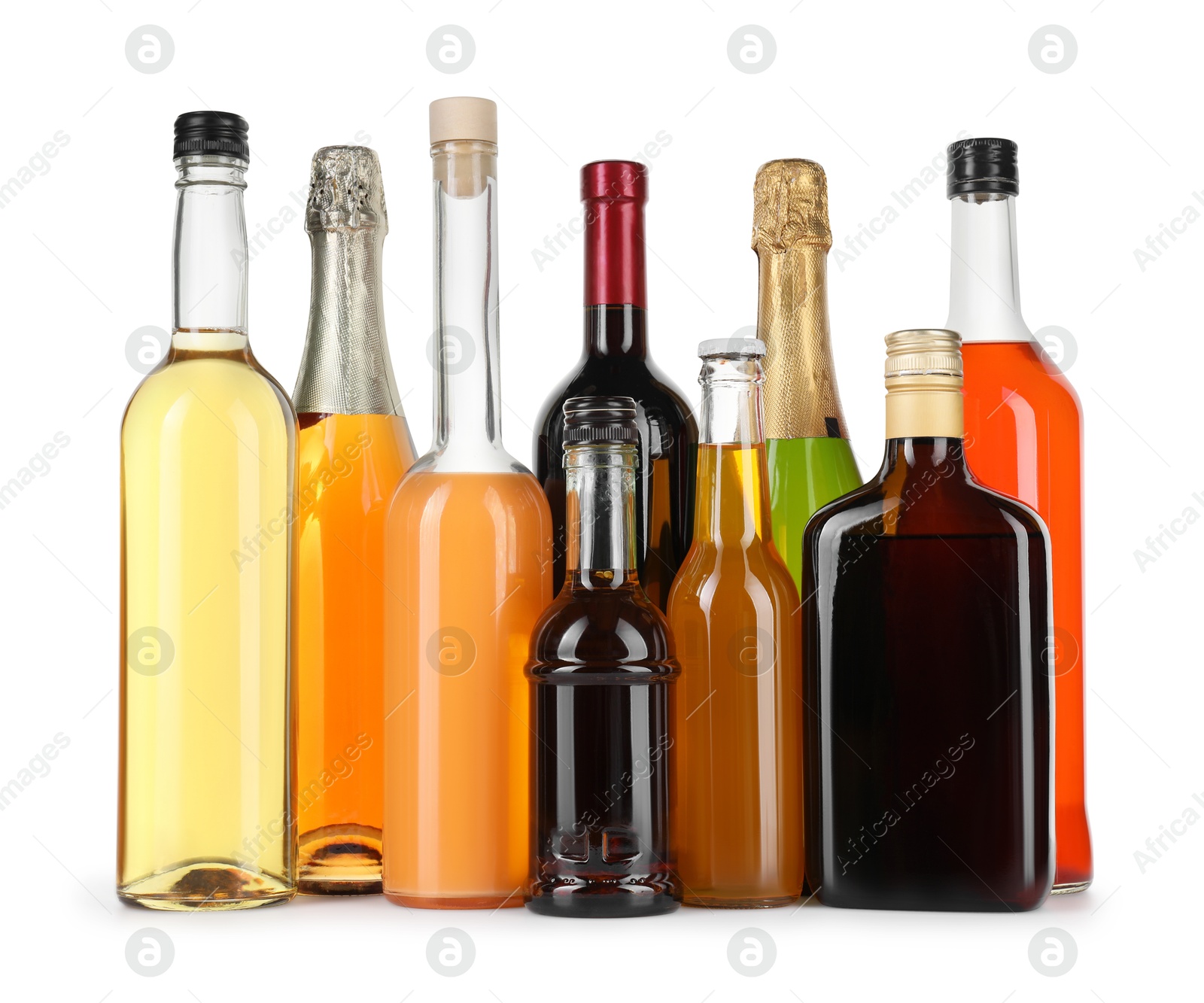 Photo of Bottles of different alcoholic drinks isolated on white