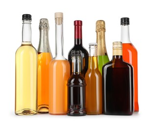 Bottles of different alcoholic drinks isolated on white