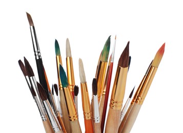 Many different paint brushes on white background