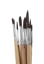 Many different paint brushes on white background