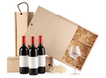 Wooden gift boxes with wine and glass isolated on white